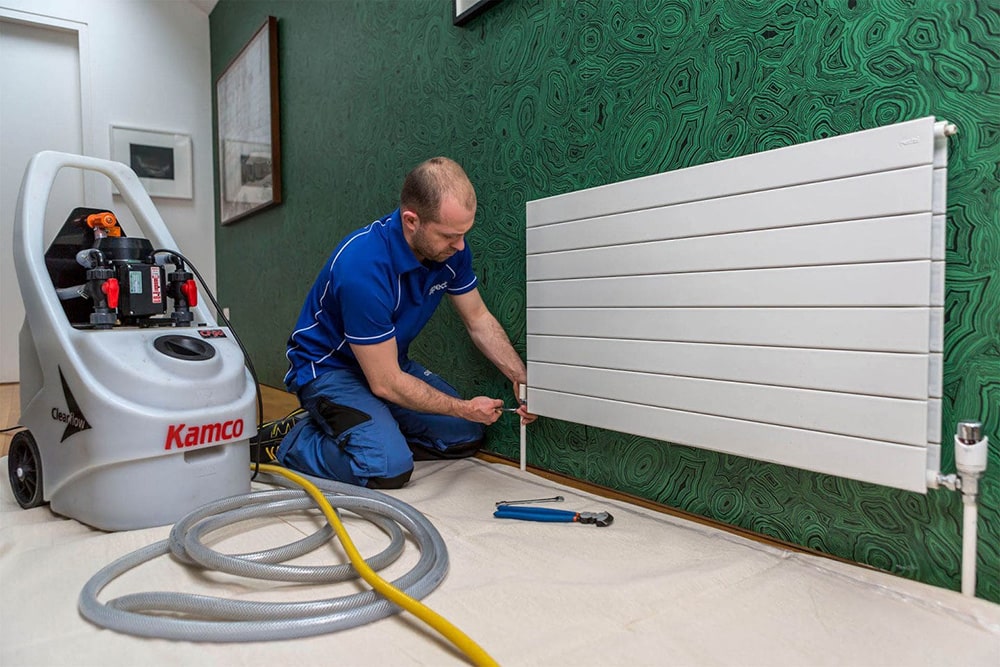 Heating engineer servicing a domestic central heating system